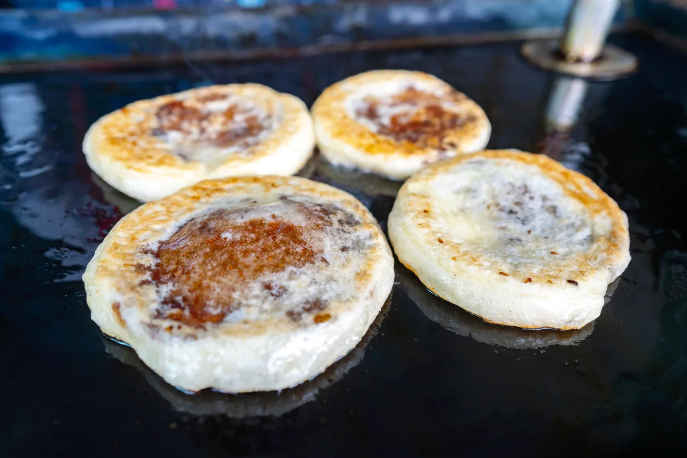 Hotteok being cooked to a lovely golden-brown.